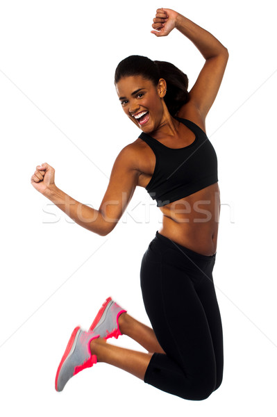 Nő sportruha ugrik öröm gyönyörű nő sportos Stock fotó © stockyimages