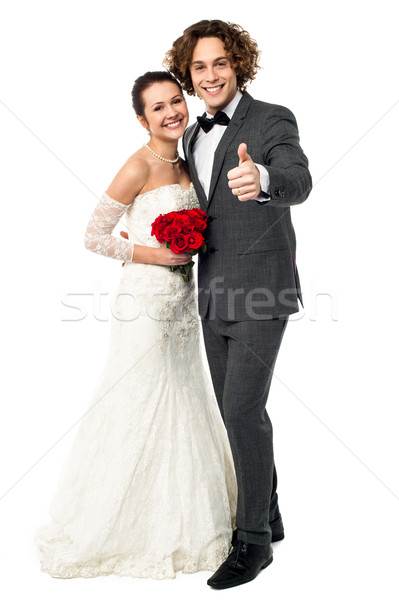 Groom with his bride showing thumbs up sign Stock photo © stockyimages