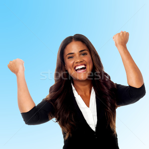 Excited businesswoman with clenched fists Stock photo © stockyimages
