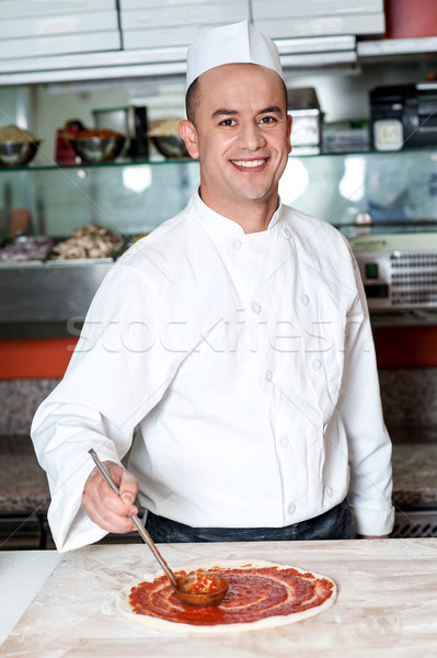 Smiling chef making pizza Stock photo © stockyimages