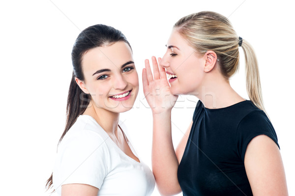 Stock photo: Young girls gossiping and having fun