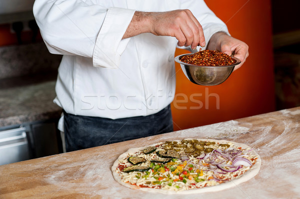 Cropped image of a chef preparing pizza Stock photo © stockyimages
