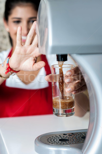 Girl filling glass with chocolate shake Stock photo © stockyimages