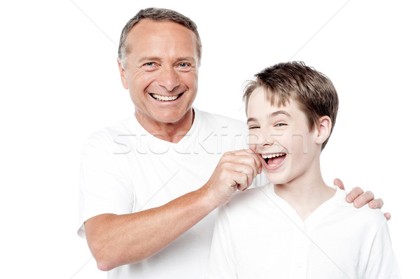 Playful father and son, pinching cheeks Stock photo © stockyimages