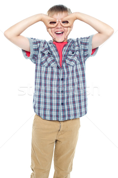 Stock photo: Boy making mock spectacles with his hands