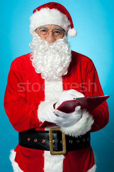 Father Nicholas preparing a list of gift recipients Stock photo © stockyimages