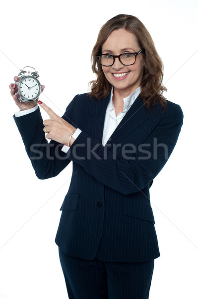 Corporate executive pointing towards the clock Stock photo © stockyimages