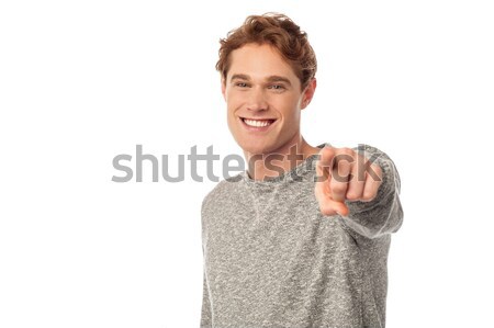 Young smiling guy pointing you out Stock photo © stockyimages