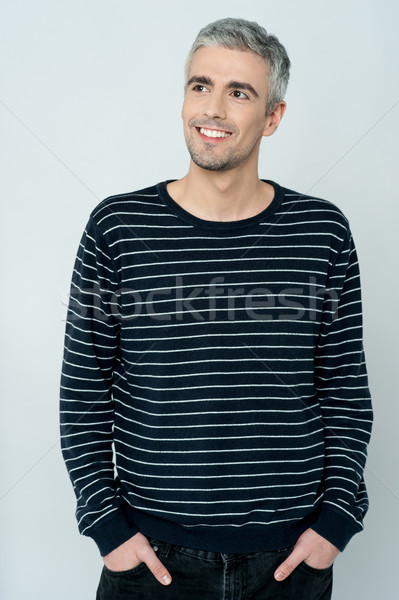 Casual shot of smiling relaxed male model Stock photo © stockyimages