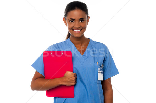 Female nurse holding clipboard, at duty Stock photo © stockyimages