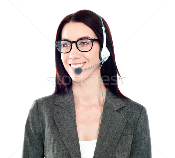 Cheerful female customer care operator looking away Stock photo © stockyimages