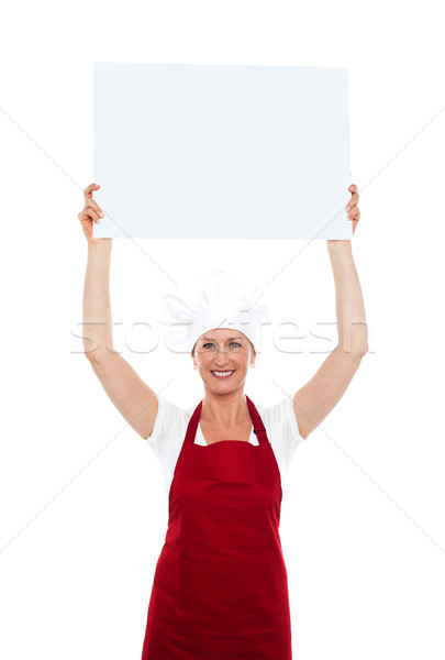 Chef holding advertising board over her head Stock photo © stockyimages