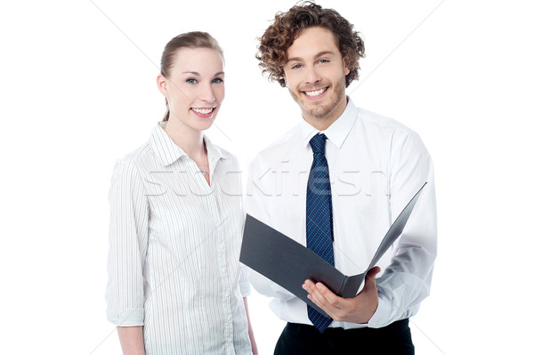 Office colleagues reviewing business file Stock photo © stockyimages