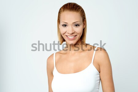 Pretty young woman smiling warmly Stock photo © stockyimages