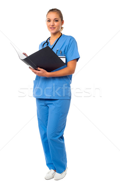 Female doctor reviewing reports Stock photo © stockyimages
