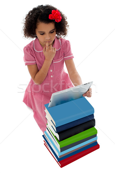 Unsure school kid using tablet pc Stock photo © stockyimages