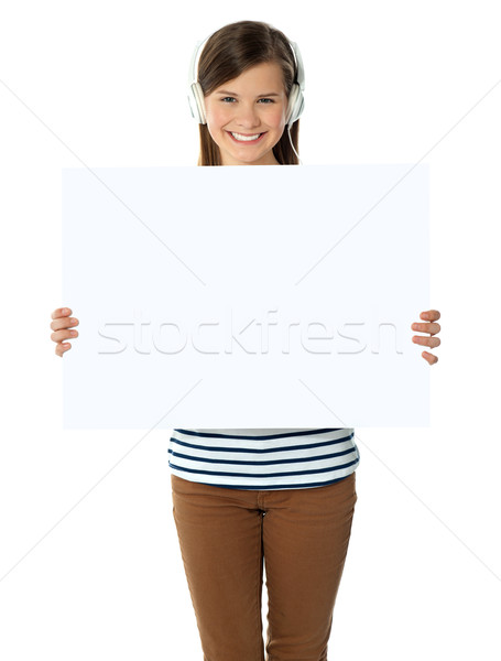 Musical girl promoting blank banner ad Stock photo © stockyimages