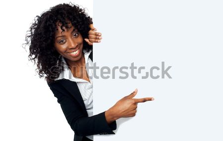Female representative pointing towards placard Stock photo © stockyimages