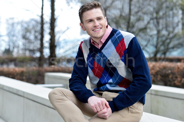 Stylish young man sitting in sidewalk Stock photo © stockyimages
