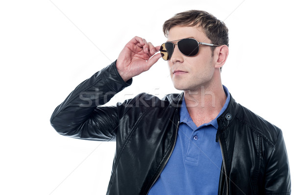 Handsome man in leather jacket looking away Stock photo © stockyimages