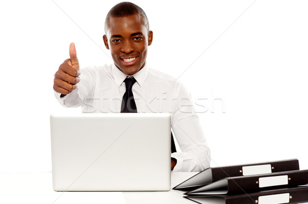 Happy young african gesturing thumbs up Stock photo © stockyimages