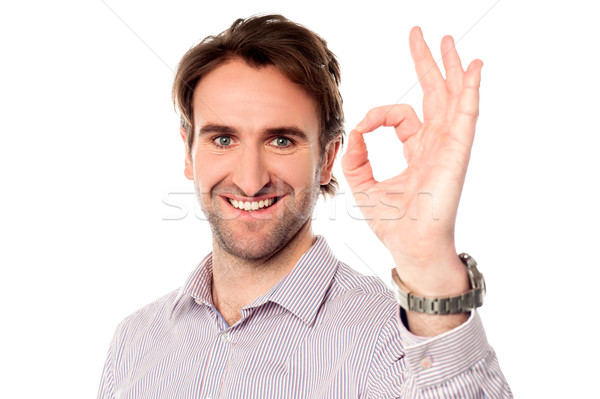 Smart man showing okay sign Stock photo © stockyimages