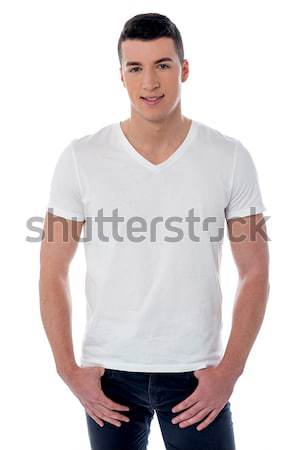 Young man with hands in his pockets Stock photo © stockyimages