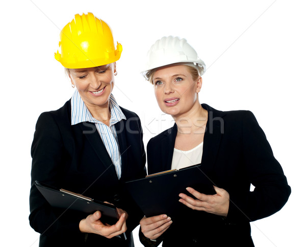 Young female architects reviewing documents Stock photo © stockyimages