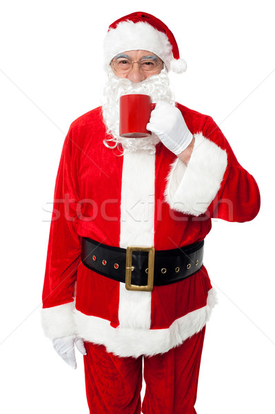 Aged smiling Santa enjoying his coffee Stock photo © stockyimages