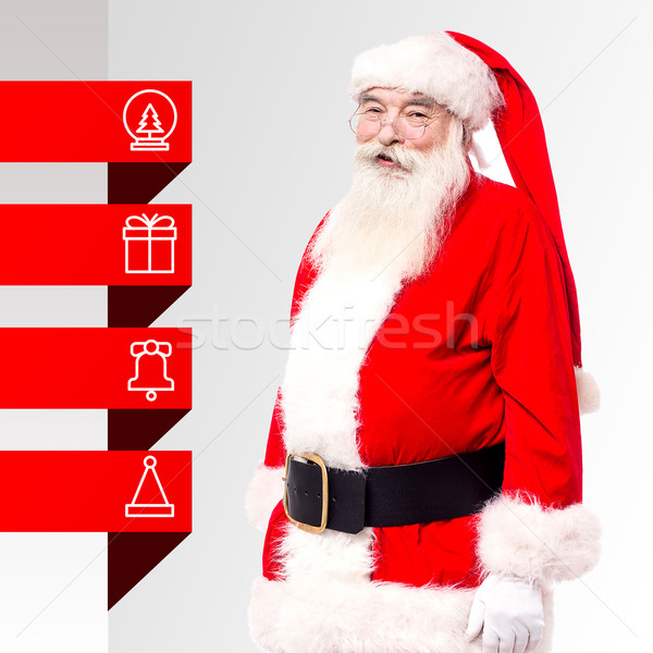 Santa standing with x-mas tags Stock photo © stockyimages