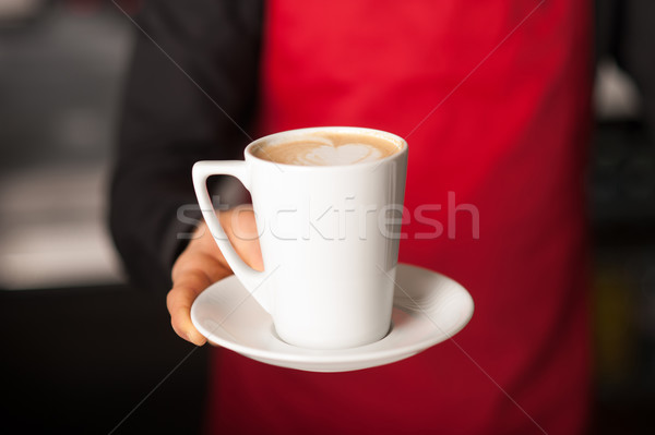 Hands of waiter serving a cup of cappucino Stock photo © stockyimages