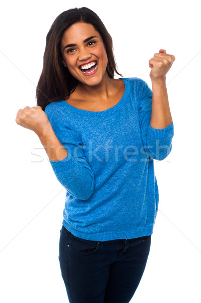 Excited pretty girl with clenched fists Stock photo © stockyimages