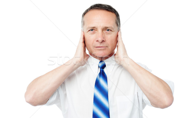 Businessman covering his ears with his hands Stock photo © stockyimages
