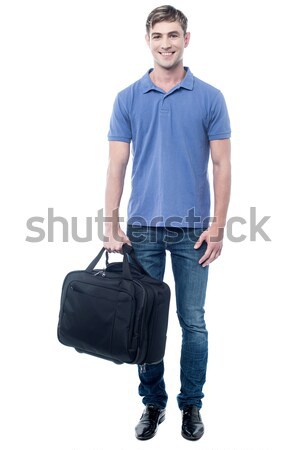 Smiling casual man standing with bag Stock photo © stockyimages