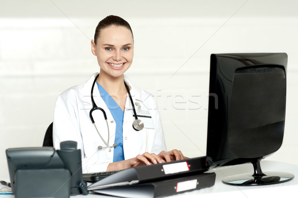 Smiling female doctor working on computer Stock photo © stockyimages
