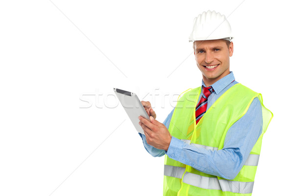 Construction engineer operating wireless device Stock photo © stockyimages