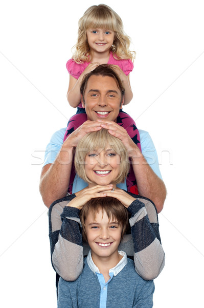 Aantrekkelijk glimlachend familie vier poseren lijn Stockfoto © stockyimages