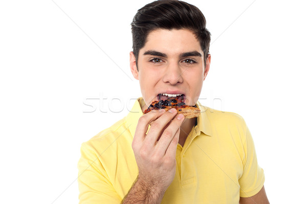 Jóképű fickó élvezi nyami pizza fehér Stock fotó © stockyimages