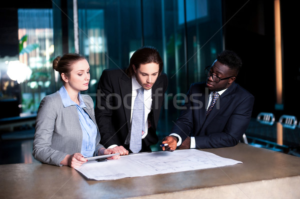 Business team of three reviewing project plan Stock photo © stockyimages