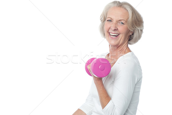 Joyous fit woman lifting dumbbells Stock photo © stockyimages