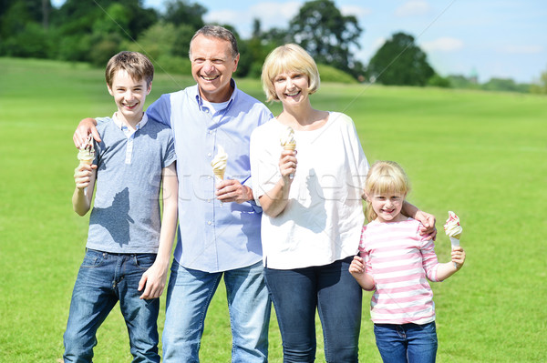 Cheerful family holding yummy ice cream cones Stock photo © stockyimages