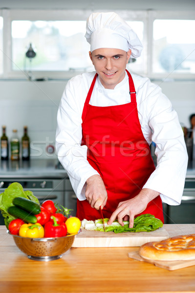 Chef chopping vegetables in kitchen  Stock photo © stockyimages