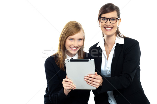 Tutor with student holding portable tablet pc Stock photo © stockyimages