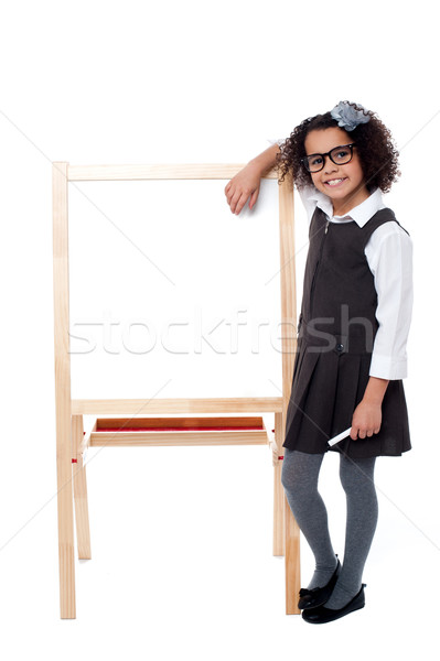 Bright student resting her hand on whiteboard Stock photo © stockyimages