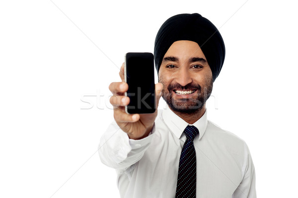 Salesman displaying newly launched mobile phone Stock photo © stockyimages