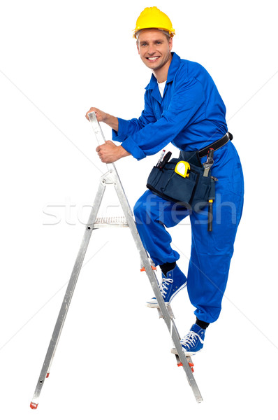 Repairman climbing up a stepladder Stock photo © stockyimages