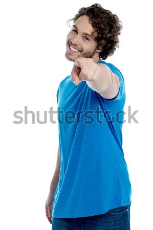 Handsome young man pointing towards camera Stock photo © stockyimages