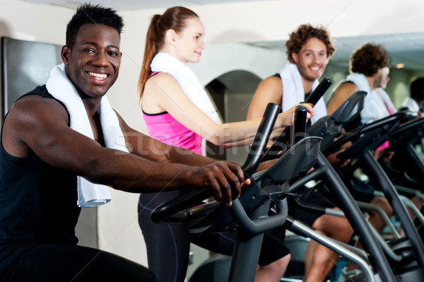 Gym trainer exercising along with his trainees Stock photo © stockyimages