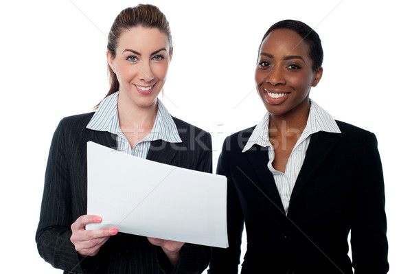 Corporate ladies reviewing reports Stock photo © stockyimages