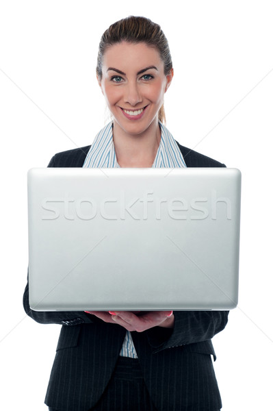 Smiling corporate lady holding brand new laptop Stock photo © stockyimages